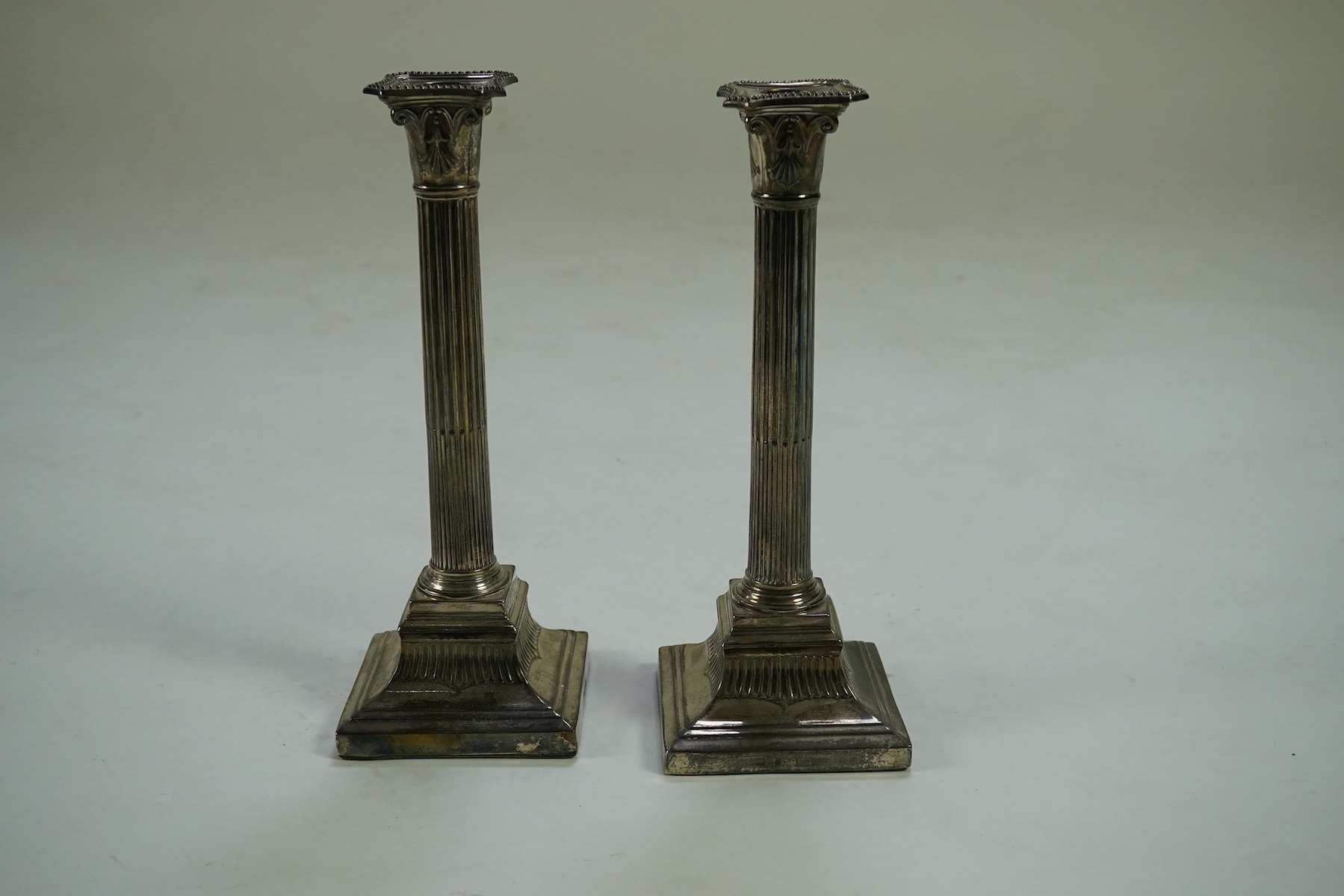 A pair of Victorian silver fluted column candlesticks, by Thomas Bradbury & Sons